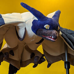 A photograph of a sleek plush wyvern with spread wings.